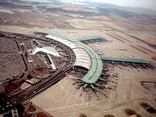 Tilted aerial view of modern airport. Aircraft are parked next to 