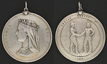 Two sides of a silver medal: the profile of Queen Victoria and the inscription 
