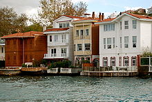 Two- and three-story colored houses with docks and balconies, built directly on the edge of the water