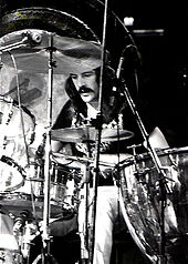 A black and white photograph of John Bonham playing drums