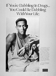  A black-and-white poster of a young black man with a towel in his left hand with the words 