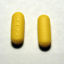 Two yellow oblong pills on one of which the markings GX623 are visible