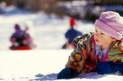 Child on the snow at Christmas time