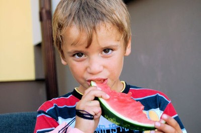 Child from Mogilev, Belarus, eating a melon