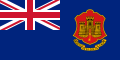 Red flag with multicoloured shield to right and Union Flag in top-left quarter.
