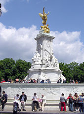 Bronze statue of winged victory mounted on a marble four-sided base with a marble figure on each side