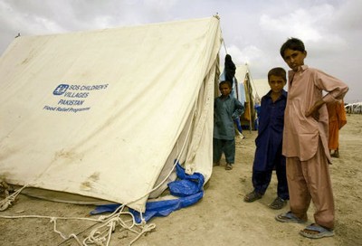 SOS Pakistan Flood Appeal Boys next to SOS tent