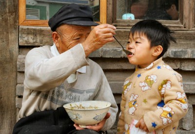 Child with his grandfather supported by SOS Social Centre in Tianjin, China