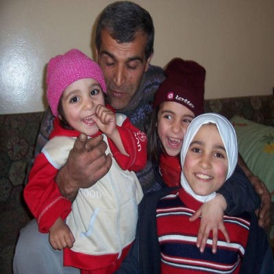 Father and children supported through family support programme in Ksarnaba, Lebanon
