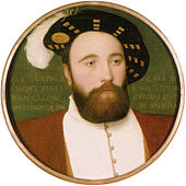 Un hombre con una espesa barba y una expresión tranquila que llevaba una chaqueta doblete y un sombrero de ala ancha