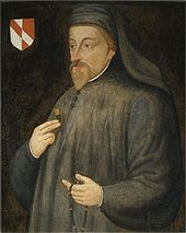 A man dressed in grey with a beard, holding a rosary, depicted next to a coat of arms.