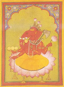 Vêtu d'un dhoti orange, un homme à tête d'éléphant est assis sur un grand lotus. Son corps est de couleur rouge et il porte différents colliers et des bracelets d'or et un serpent autour de son cou. Sur les trois points de sa couronne, lotus en herbe ont été corrigés. Il tient dans ses deux mains droites le chapelet (main inférieure) et une tasse remplie avec trois modakas (rondes de bonbons jaunes), quart modaka tenu par le tronc courbe est à peu près à être dégusté. Dans ses deux mains gauches, il tient un lotus ci-dessus et ci-dessous une hache, avec son manche appuyé contre son épaule.