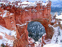 A grande abertura no vermelho vermelho com neve no topo