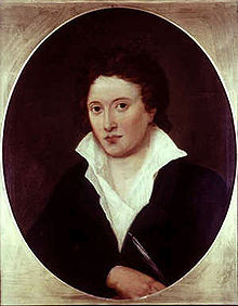 Retrato oval metade do comprimento de um homem vestindo uma jaqueta preta e uma camisa branca, o que é torto e aberta ao peito.