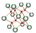 Ball and stick model of cubic-like crystal structure containing two types of atoms.