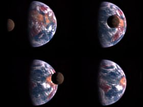 The dark shadowed disk of the Moon moves across the face of the quarter-phase Earth, covering only a small part of the cloud-swirled semicircle.