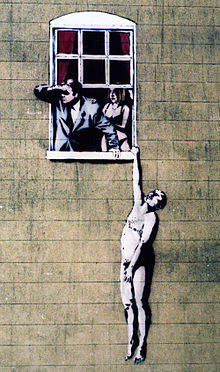 A painting on a building showing a naked man hanging by one hand from a window sill. A man in a suit looks out of the window, shading his eyes with his right hand, behind him stands a woman in her underwear.
