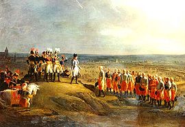 Pintura colorida que descreve Napoleon receber a rendição dos generais austríacos, com os exércitos inimigos e da cidade de Ulm no fundo