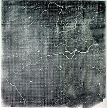 An image, probably a printout of a photograph, of a map of eastern China, complete with rivers. The area of the map covered by land features a near perfect grid pattern, which because it does not overlap any text, is clearly the work of the original mapmaker.